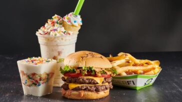 When did BurgerFi start franchising?