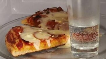 Why do you put a cup of water in the microwave with pizza?